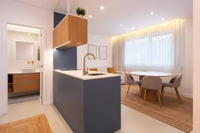 a kitchen and dining room with a sink and a table at DoisPontoZero NAVY in Porto