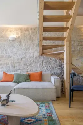 a living room with a couch and a staircase at Portobliss Apartment in Porto