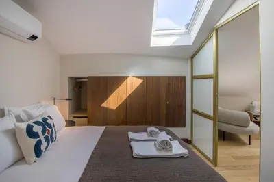 a bedroom with a bed with two towels on it at Portobliss Apartment in Porto