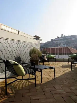 a row of benches sitting on top of a roof at Oporto Serviced Apartments - Miragaia II in Porto