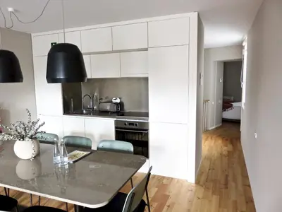 a kitchen with a table and chairs in a room at Oporto Serviced Apartments - Miragaia II in Porto