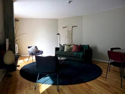 a living room with a green couch and chairs at Oporto Serviced Apartments - Miragaia II in Porto
