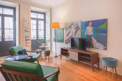 a living room with a tv and a painting on the wall at Once Upon In Porto Apartments II in Porto