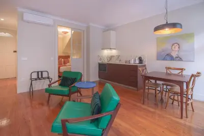 a living room with a table and chairs and a kitchen at Once Upon In Porto Apartments II in Porto