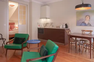 a kitchen and living room with a table and chairs at Once Upon In Porto Apartments II in Porto