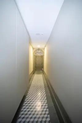 a hallway with a door and a tile floor at Once Upon in Porto Apartments I in Porto