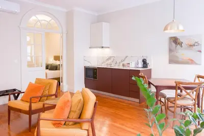 a kitchen and living room with a table and chairs at Once Upon in Porto Apartments I in Porto