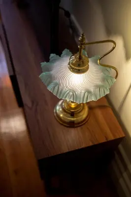 a glass lamp sitting on a wooden table at Once Upon in Porto Apartments I in Porto