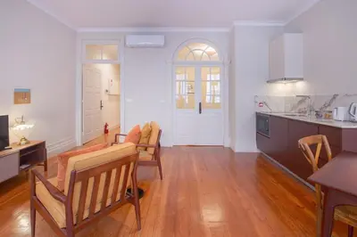 a kitchen and living room with a table and chairs at Once Upon in Porto Apartments I in Porto