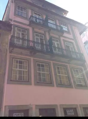 a tall building with windows and a balcony at Porto Chique AL 5 in Porto
