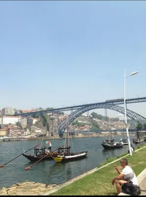 two boats in a river with a bridge in the background at Porto Chique AL 5 in Porto