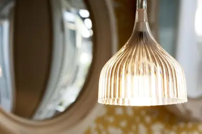 a light hanging in front of a mirror at In Porto Gallery Guesthouse in Porto