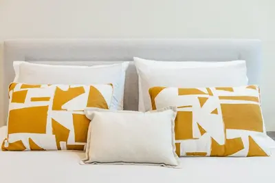 a bedroom with a white bed and a closet at Casa da Música Modern Flat in Porto
