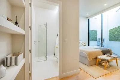 a bathroom with a glass shower and a sink at Casa da Música Modern Flat in Porto