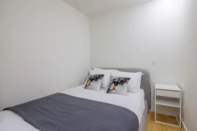 a bedroom with a white bed with two pillows at Aliados Living Apartment in Porto