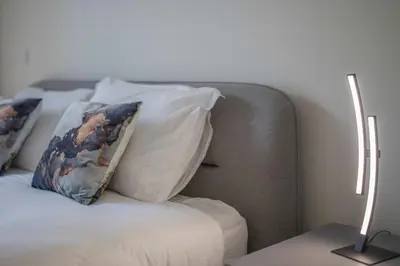 a couch with two pillows on it in a room at Aliados Living Apartment in Porto
