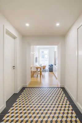 an empty living room with a checkered floor at Aliados Living Apartment in Porto