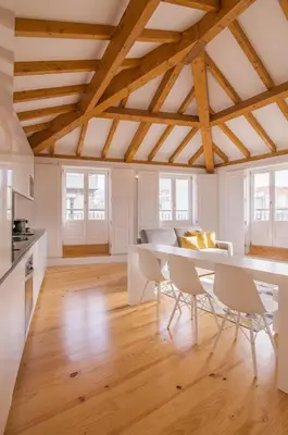 a kitchen and dining room with a table and chairs at Almada Prime Apartment II in Porto