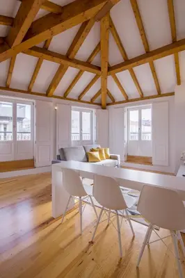 a living room with a table and chairs at Almada Prime Apartment II in Porto