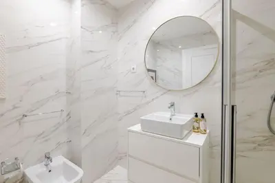 a white hallway with a toilet and a mirror at Almada Prime III in Porto