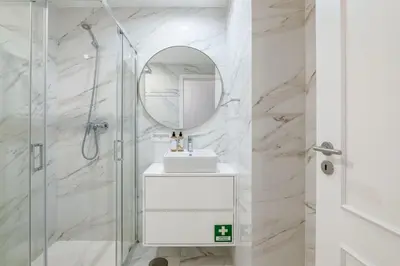 a white bathroom with a sink and a mirror at Almada Prime III in Porto