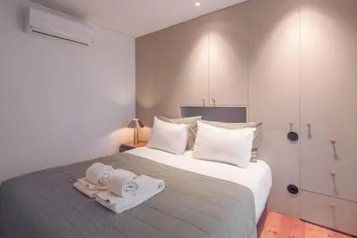 a bedroom with a bed with towels on it at Andrade Rooftop Duplex in Porto