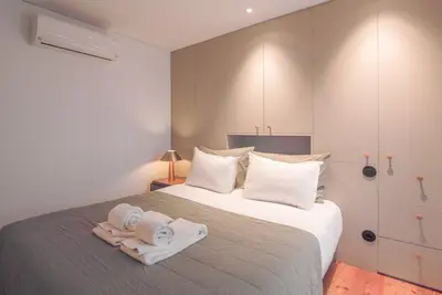 a bedroom with a bed with towels on it at Andrade Rooftop Duplex in Porto