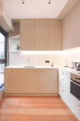 a kitchen with white cabinets and a sink at Andrade Rooftop Duplex in Porto