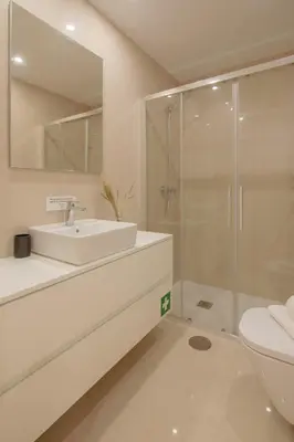 a white bathroom with a sink and a shower at Canto Flores in Porto
