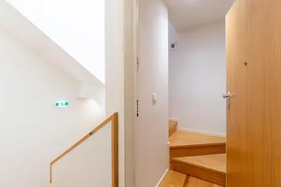 a hallway with a stairway leading to a room at Catedral da Sé Apartment in Porto