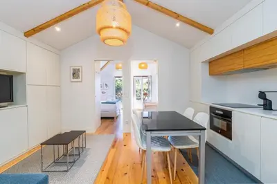 a kitchen and dining room with a table and chairs at Catedral da Sé Apartment in Porto