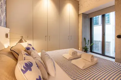 a bedroom with a bed with towels on it at Charming Blue Apartment in Porto