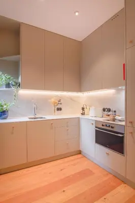 a kitchen with white cabinets and a sink at Charming Blue Apartment in Porto