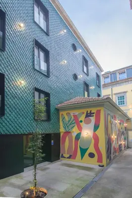 a building with a painting on the side of it at Charming Blue Apartment in Porto