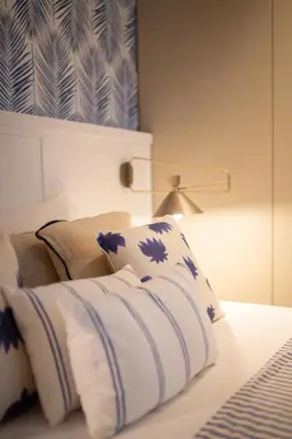 a bedroom with a bed with blue and white pillows at Charming Blue Apartment in Porto