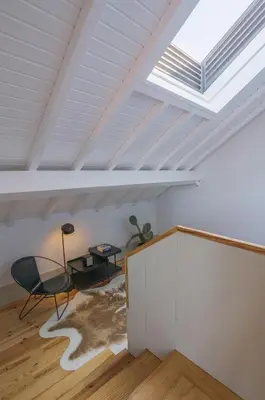 a skylight in a room with a table and a chair at Rua Formosa 99 in Porto