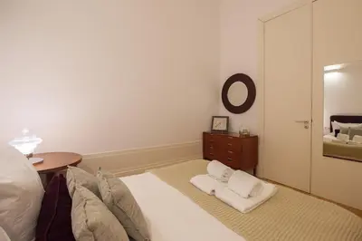 a bedroom with a bed and a table and a mirror at Mouzinho Hill View in Porto