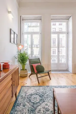 a living room with a chair and a table at Mouzinho Hill View in Porto