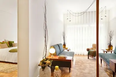 a living room with a couch and a bed at VIVA Cozy Downtown in Porto