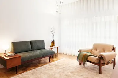 a living room with a couch and a chair at VIVA Cozy Downtown in Porto
