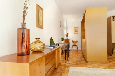 a living room with a vase on a wooden desk at VIVA Cozy Downtown in Porto