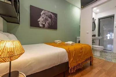 a bedroom with a bed with a lion on the wall at River Corticeira II in Porto