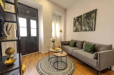 a living room with a couch and a table at River Corticeira II in Porto