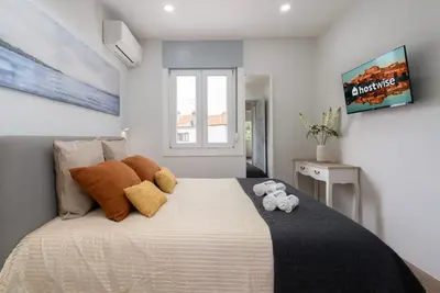 a bedroom with a large bed with two stuffed animals on it at Charming Bright House w/ Garden by HostWise in Porto