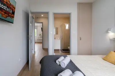 a bedroom with a bed with towels on it at Charming Bright House w/ Garden by HostWise in Porto
