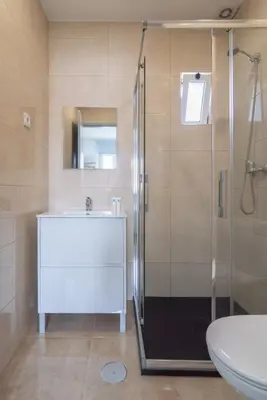 a bathroom with a shower and a sink and a toilet at Charming Bright House w/ Garden by HostWise in Porto