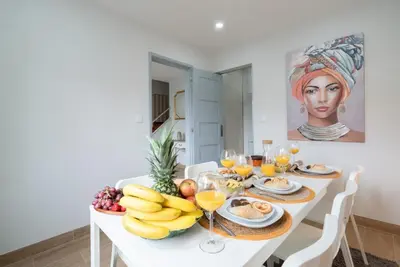 a white table with fruit and wine glasses at Charming Bright House w/ Garden by HostWise in Porto