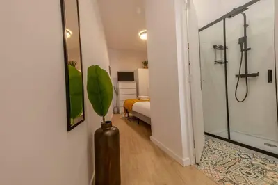 a bathroom with a shower and a vase with a plant at River Sight Corticeira III in Porto