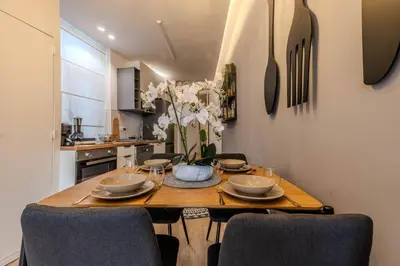 a dining room with a wooden table and chairs at River Sight Corticeira III in Porto