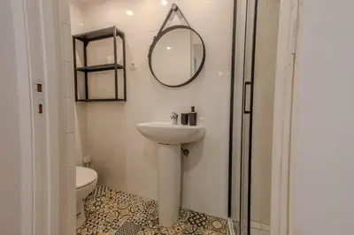 a bathroom with a sink and a mirror and a toilet at River Corticeira I in Porto